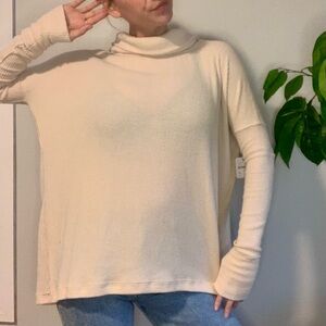 NWT “We The Free” Cream Cowl Neck/turtle neck sweater with open back.